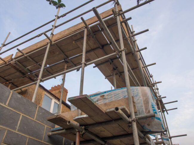 a house extension during construction surrounded by scaffolding